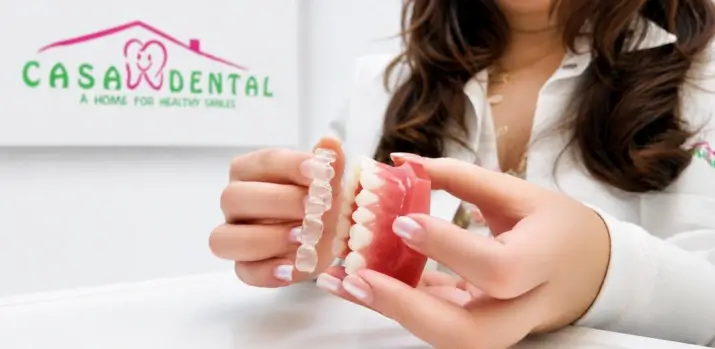 Demonstration of Invisalign aligners and SmartForce attachment placement during fitting appointment